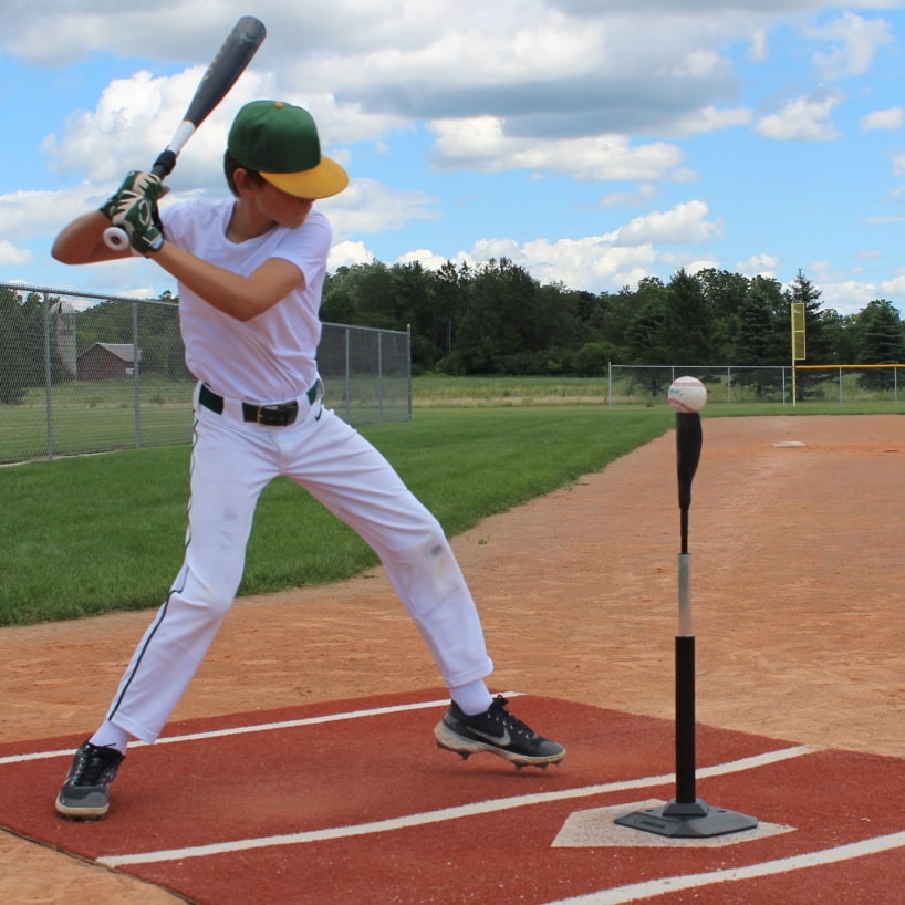 pro batting tee side view of baseball player hitting a ball