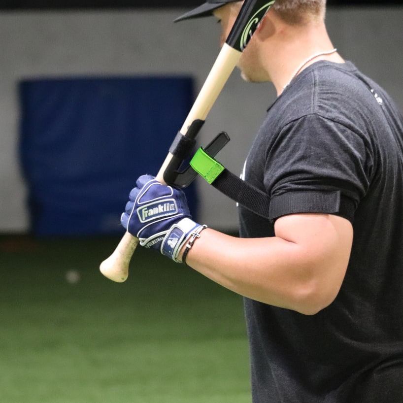 left hand baseball player shown with swingrail swing trainer
